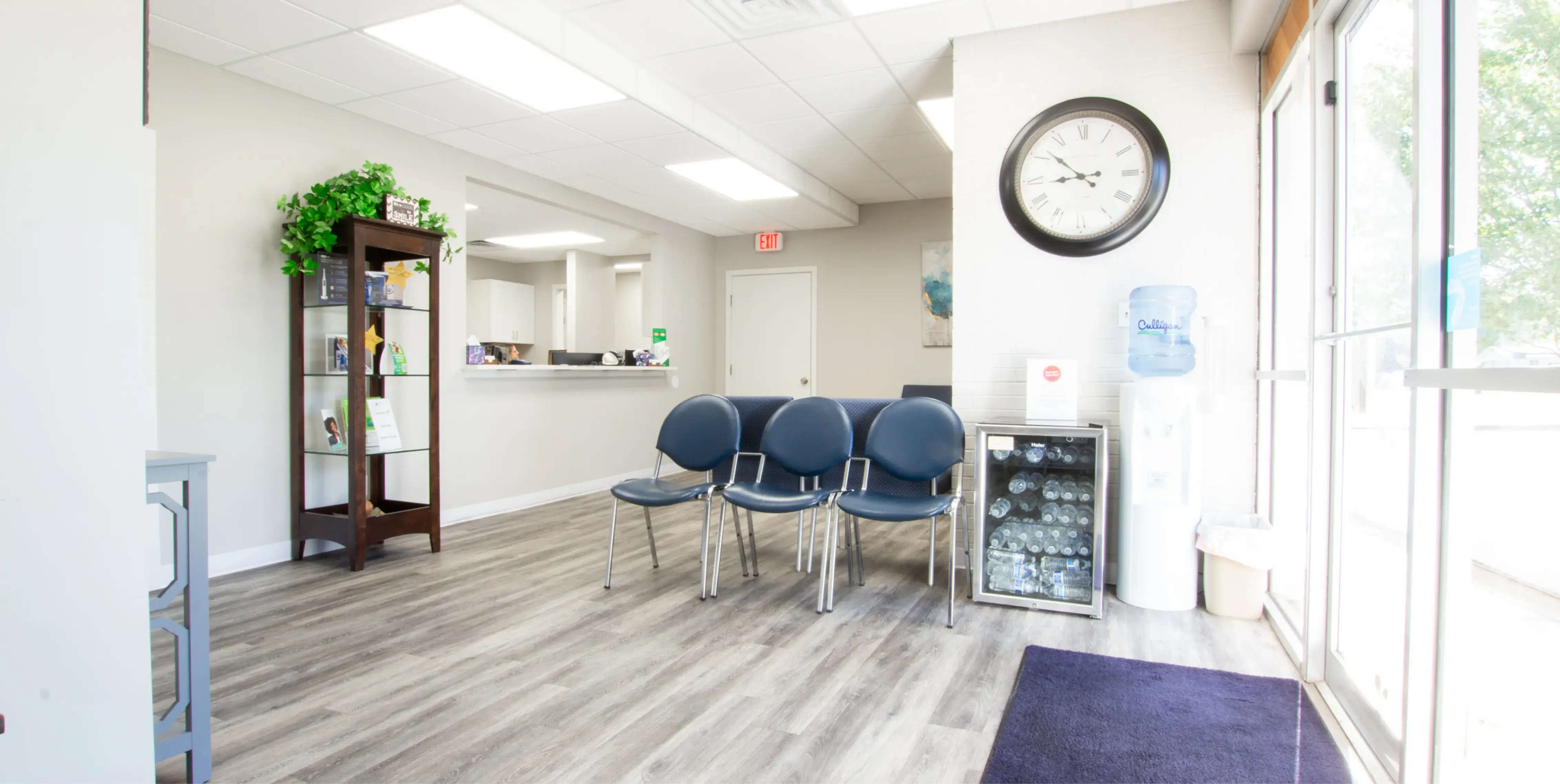 a waiting room with chairs and a clock on the wall