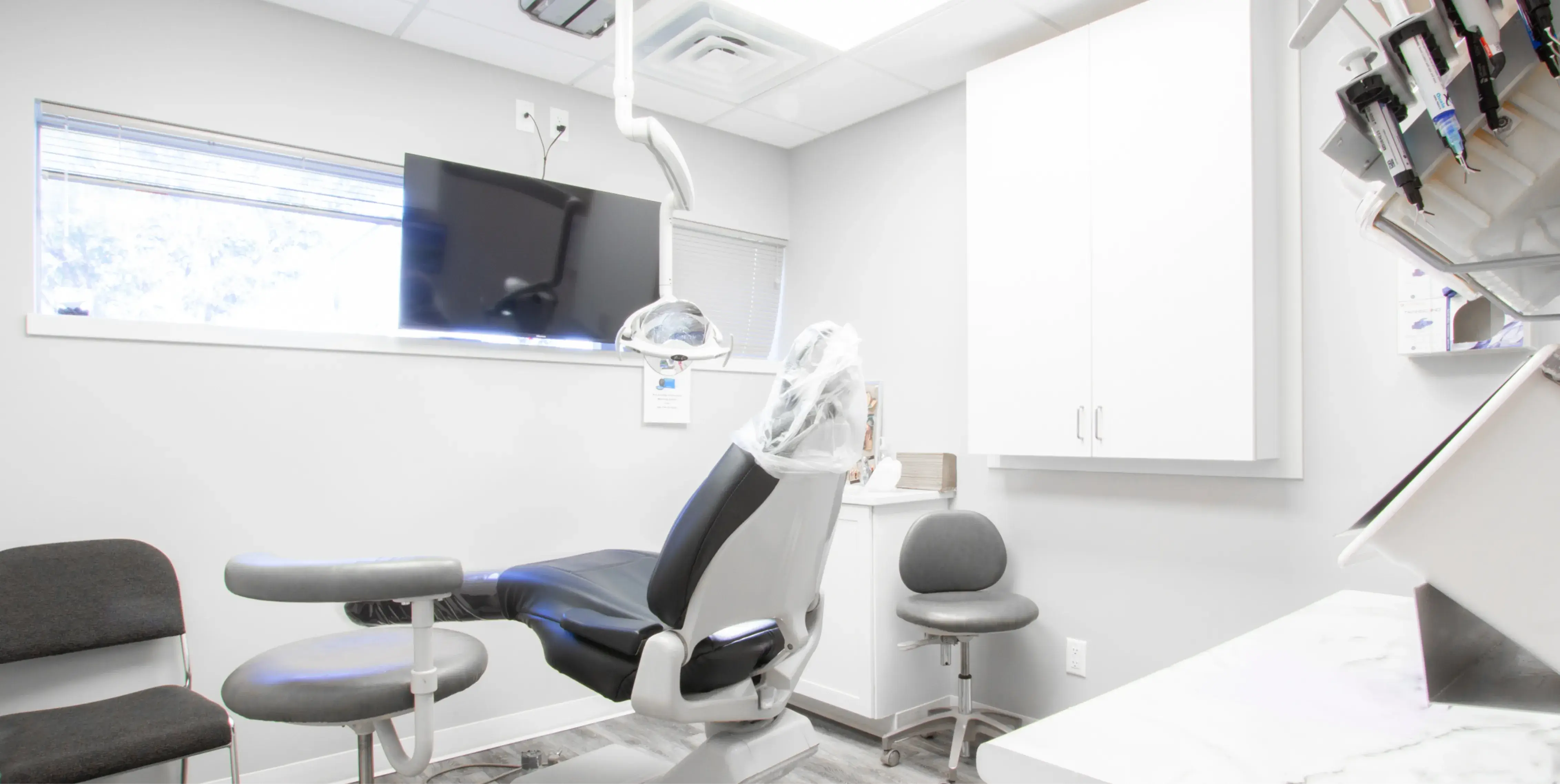 a dentist's office with chairs and a television
