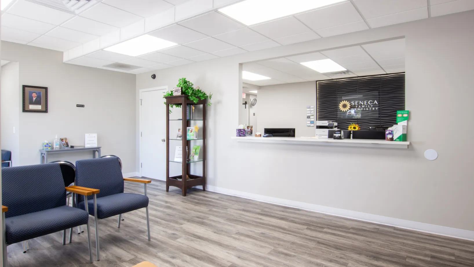 a waiting room with chairs and a sign on the wall