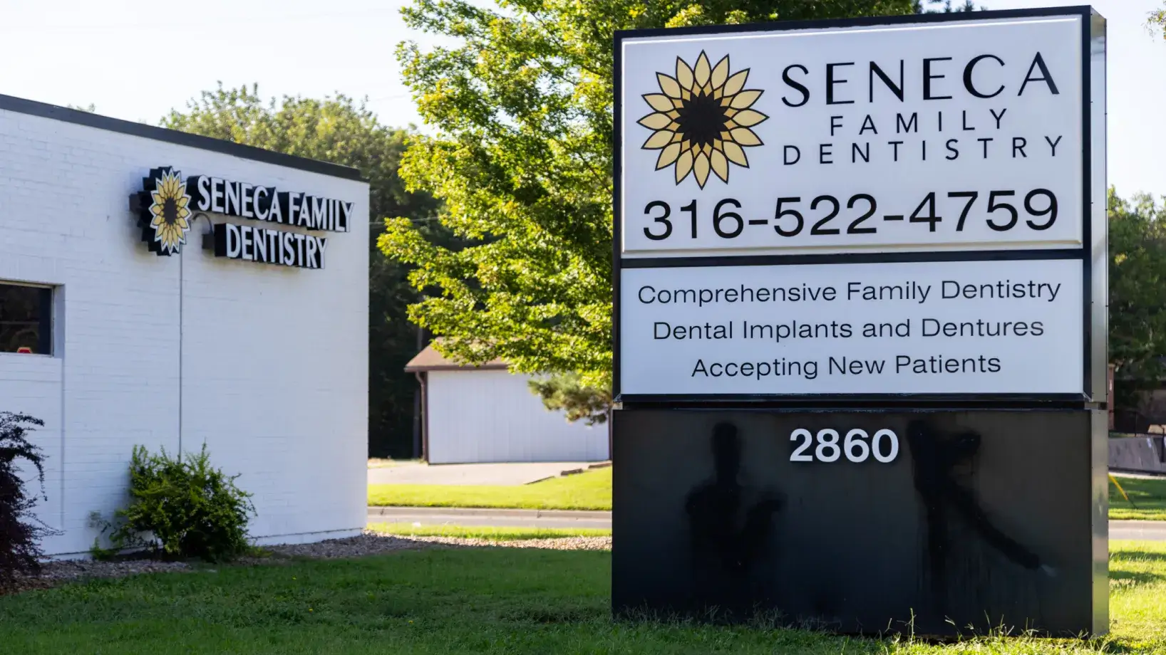 a sign in front of a dentist's office