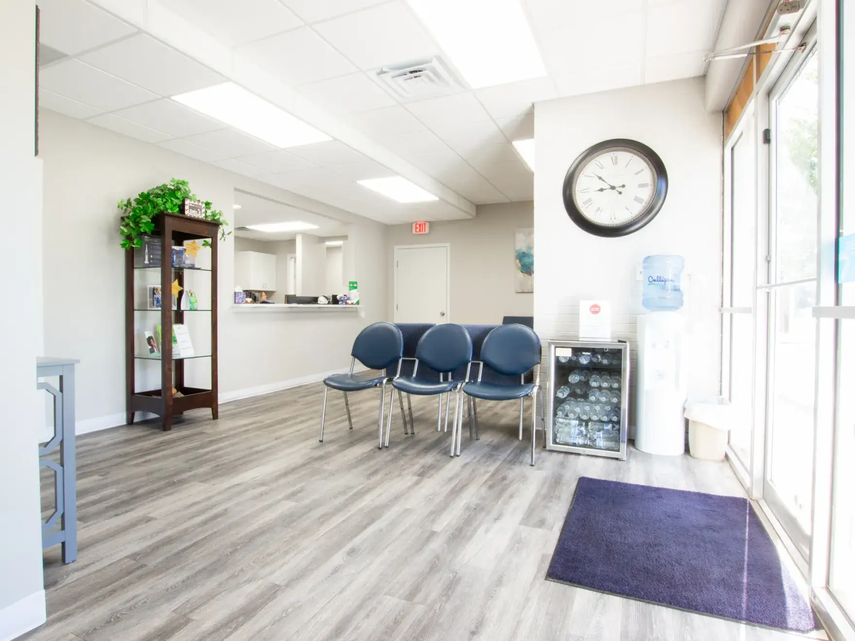 a waiting room with chairs and a clock on the wall
